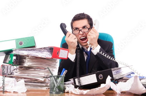 Photo: Young busy businessman at his desk Young busy businessman at his desk