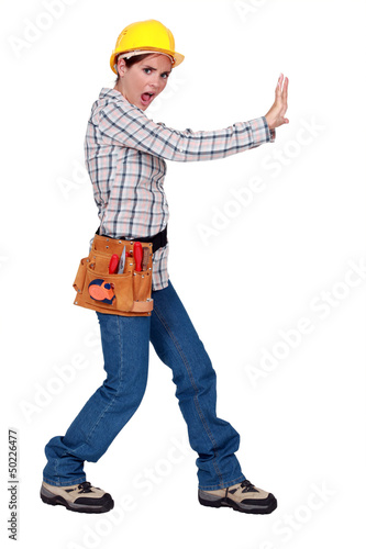 Photo: Woman pushing against an imaginary wall Woman pushing against an imaginary wall