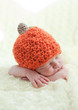 newborn in a cap pumpkin