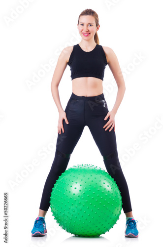 Photo: Young girl with swiss ball doing exercise Young girl with swiss ball doing exercise
