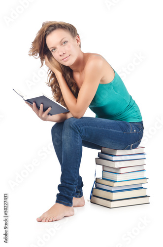 Photo: Student sitting on stack of books Student sitting on stack of books