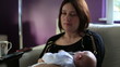 mother with little baby watching television at home
