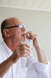 Senior man taking his medicine