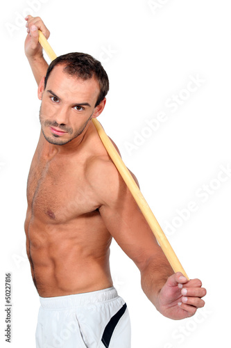 Photo: man doing exercises with a stick man doing exercises with a stick