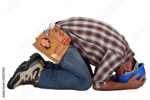 Photo: Tradesman with his head in his hands Tradesman with his head in his hands