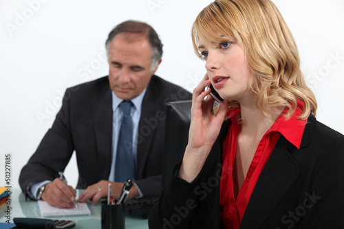 Photo: Businesswoman on the phone in office Businesswoman on the phone in office