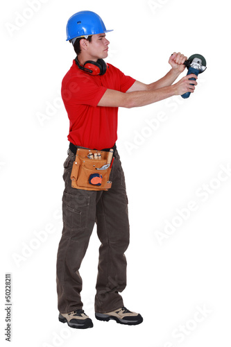 Photo: Laborer using angle-grinder Laborer using angle-grinder