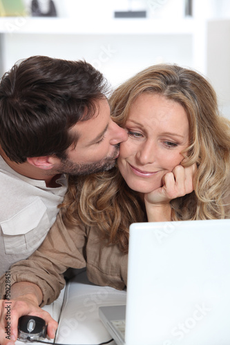 Photo: Husband kisses wife on the cheek. Husband kisses wife on the cheek.