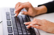 Hands working on the keyboard