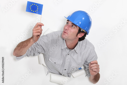 Photo: Builder waving a European flag Builder waving a European flag