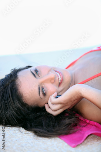 Photo: woman on the beach talking on her cell woman on the beach talking on her cell