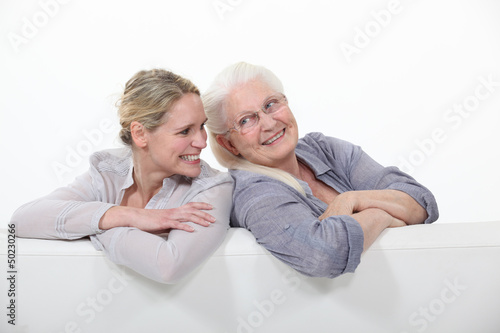 Photo: Two women on a white sofa Two women on a white sofa