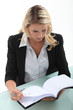 Secretary leafing through an agenda
