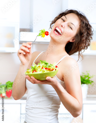 Photo: Diet. Beautiful Young Woman Eating Vegetable Salad Diet. Beautiful Young Woman Eating Vegetable Salad