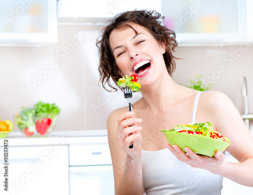 Photo: Diet. Beautiful Young Woman Eating Vegetable Salad Diet. Beautiful Young Woman Eating Vegetable Salad
