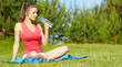 Outdoor workout woman. Fitness woman runner relaxing drinking wa