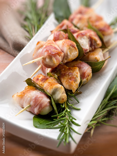 Photo: skewer with chicken and bacon, selective focus skewer with chicken and bacon, selective focus