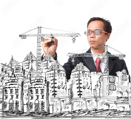 Photo: man drawing modern building construction man drawing modern building construction