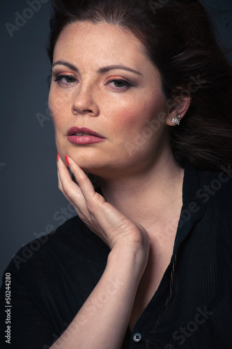 Photo: Sensual red head woman close up portrait on dark background. Sensual red head woman close up portrait on dark background.