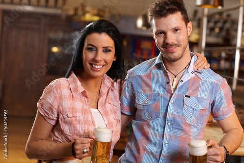 Photo: Portrait of happy young couple in pub Portrait of happy young couple in pub