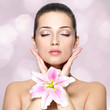 Beauty face of young woman with flower.