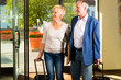 Senior married couple arriving at Hotel