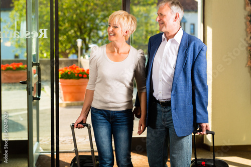 Photo: Senior married couple arriving at Hotel Senior married couple arriving at Hotel