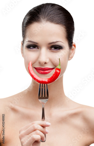 Photo: Woman with .chilli pepper on fork, isolated on white Woman with .chilli pepper on fork, isolated on white