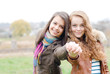 Photo: Brunette and blond haired girls friends laughing Brunette and blond haired girls friends laughing
