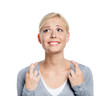 Woman with fingers crossed, isolated on white