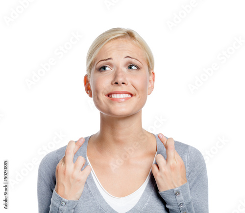 Photo: Woman with fingers crossed, isolated on white Woman with fingers crossed, isolated on white