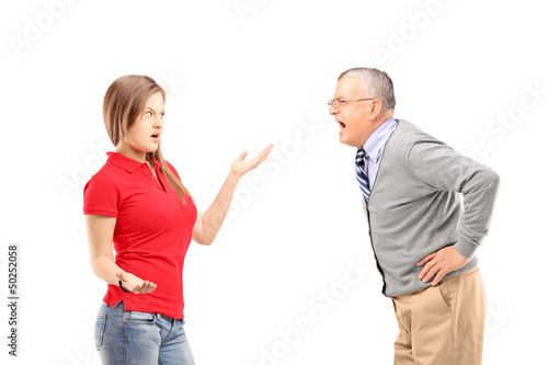 Photo: Angry mature man shouting at a young female Angry mature man shouting at a young female