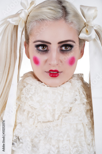Photo: Portrait of a cute blond girl with dolly makeup Portrait of a cute blond girl with dolly makeup