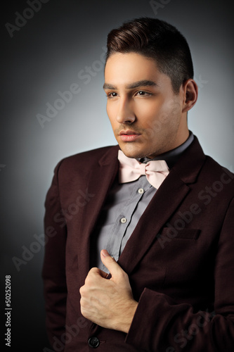 Photo: Sophisticated young man posing in a suit Sophisticated young man posing in a suit