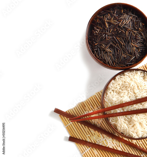 Photo: Bowls of uncooked white and wild rice on white background Bowls of uncooked white and wild rice on white background