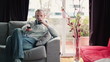 Happy man on sofa watching tv at home