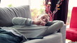 Bored man on sofa watching tv at home