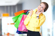 Shopping woman with phone and color bags
