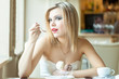 A woman in the restaurant is eating ice cream