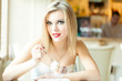 A woman in the restaurant is eating ice cream