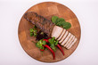 round träskärbräda with sliced ​​pork, salad and chili