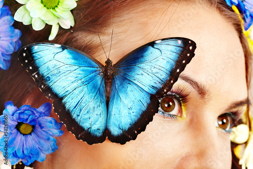 Photo: Woman with flower and butterfly. Woman with flower and butterfly.