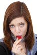 Foto: young beautiful woman eating a strawberry young beautiful woman eating a strawberry