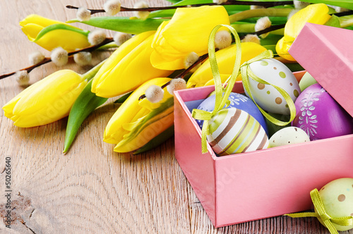 Photo: Colorful Easter eggs in open gift box Colorful Easter eggs in open gift box