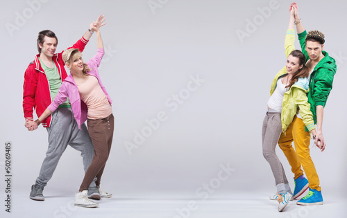 Photo: Two hip-hop couples dance and smile Two hip-hop couples dance and smile