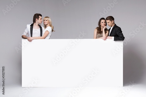 Photo: Two couples of friends relaxing together Two couples of friends relaxing together