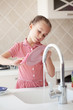 Little girl washing the dishes