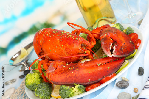 Photo: Red lobster on platter on serving table close-up Red lobster on platter on serving table close-up