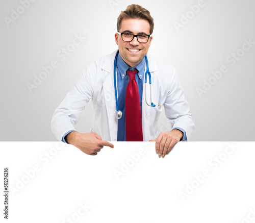 Photo: Doctor showing a white board Doctor showing a white board