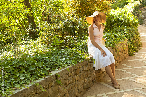 Photo: Beautiful caucasian woman in white dress sitting Beautiful caucasian woman in white dress sitting